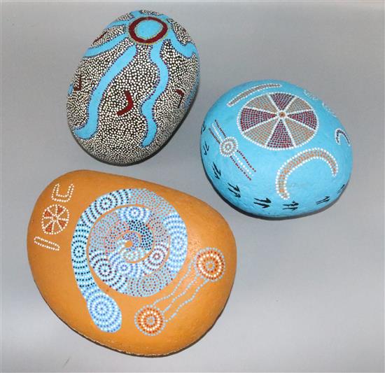 3 painted stones in the style of Maori Tribal Art